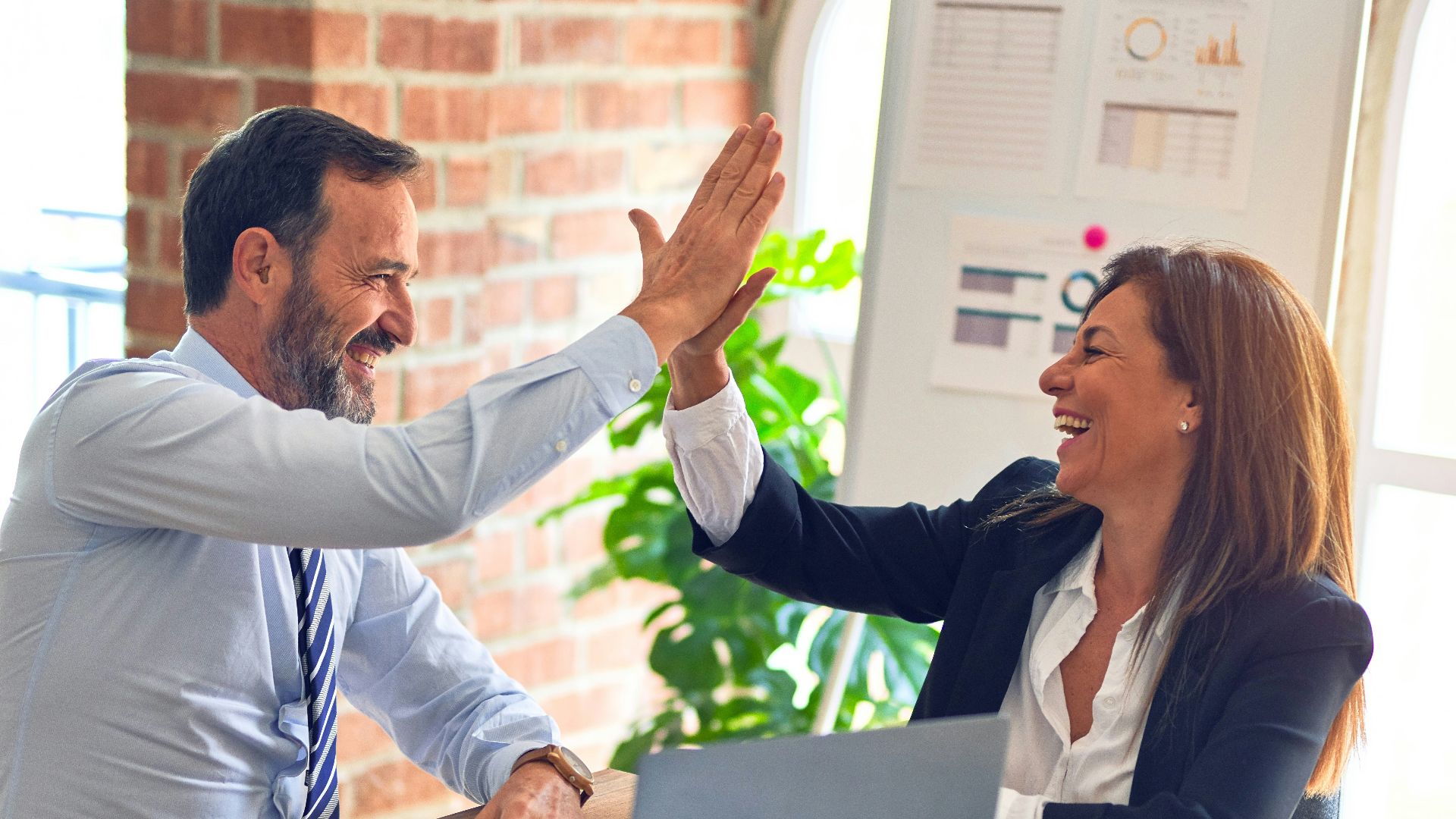 man in white dress shirt sitting beside woman in black long sleeve shirt