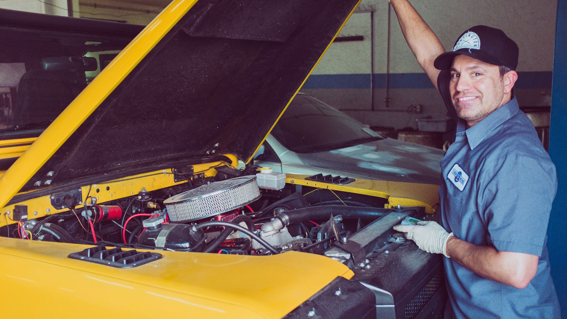 man holding open-wide car trunk