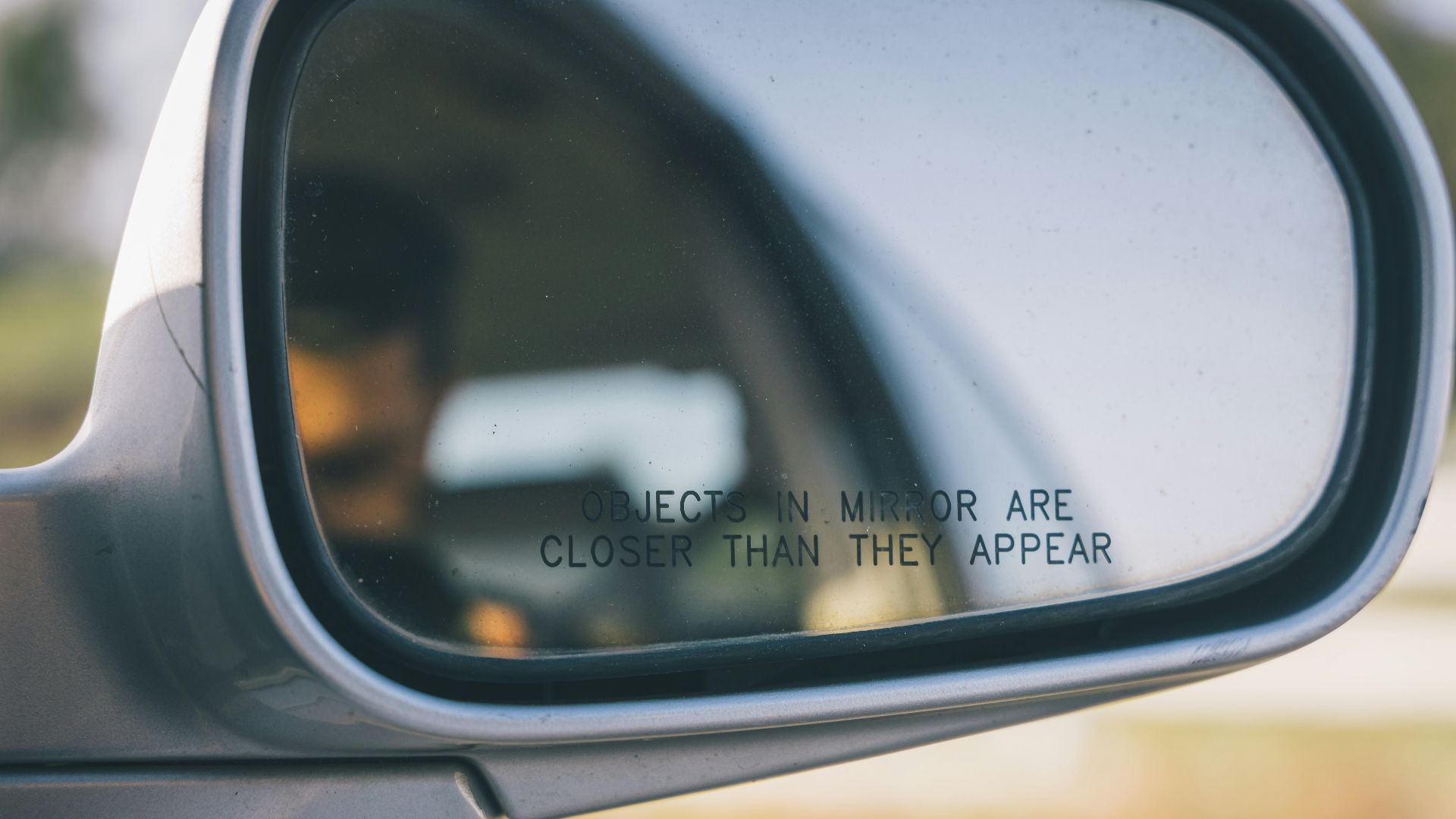 a rear view mirror with a quote on it
