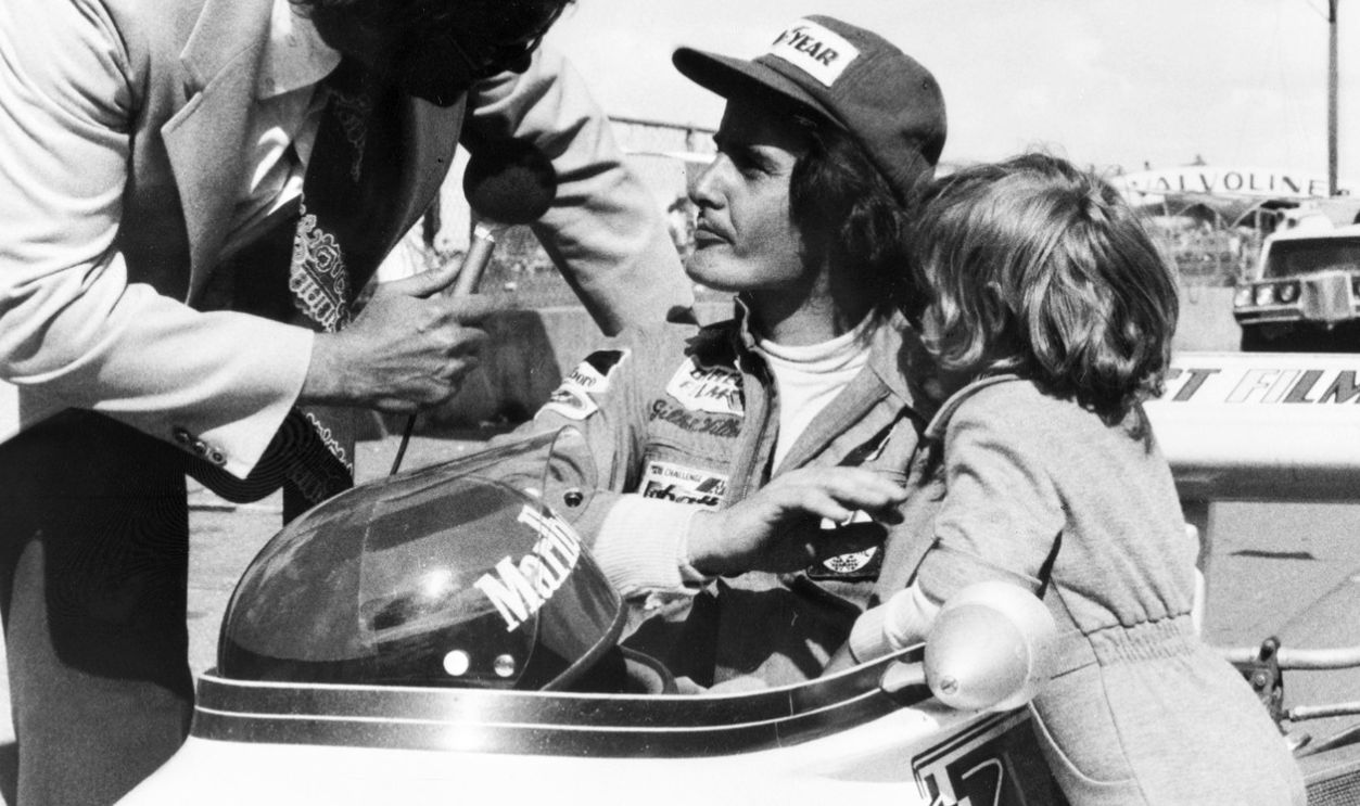 Gettyimages - 51656501, An unlocated photo taken in 1974 shows Gilles Vill An unlocated photo taken in 1974 shows Gilles Villeneuve (C) of Canada being interviewed in his car as his son Jacques (R) stands by.