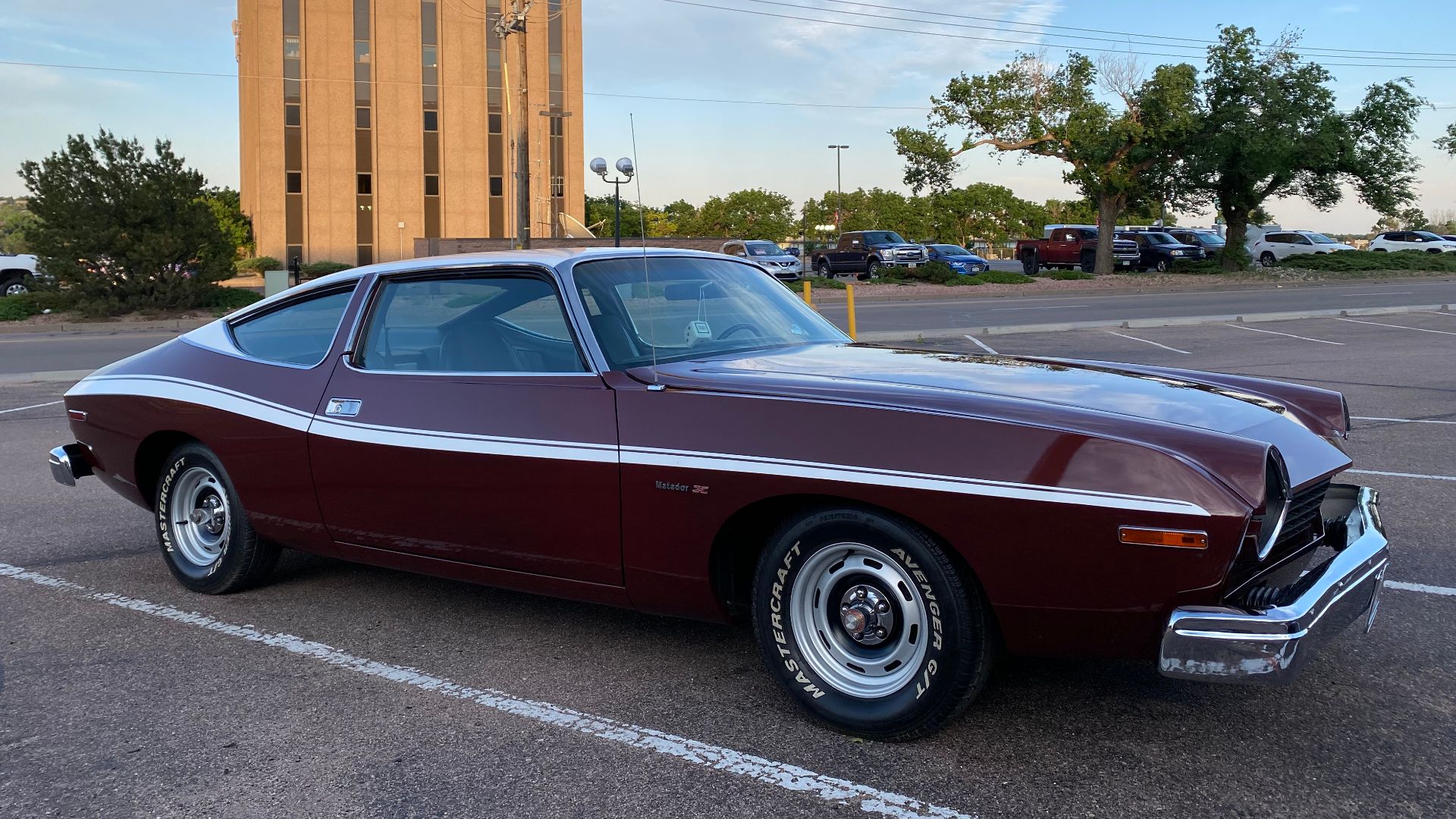 File:1974 AMC Matador X coupe in burgundy with white stripe and roof at 2021 AMO meet 2of6.jpg