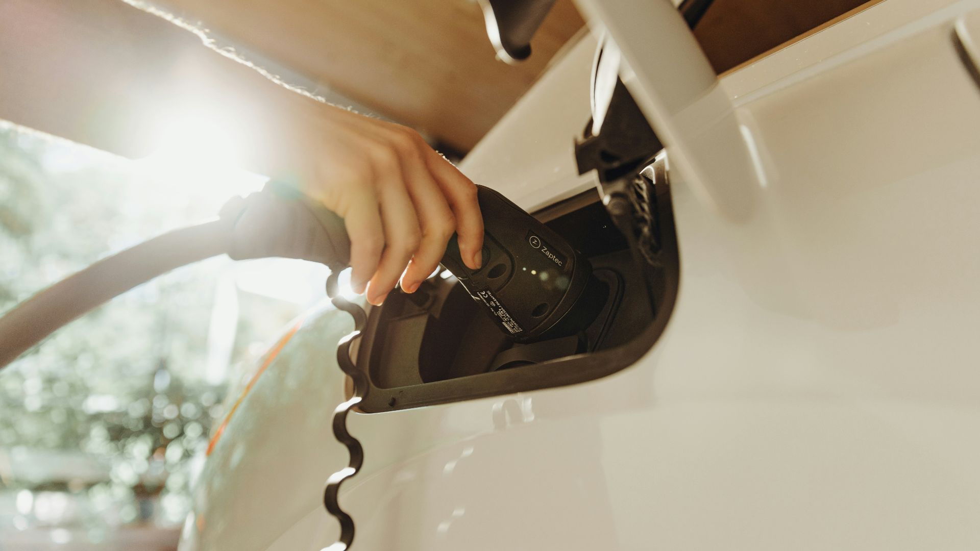 a person pumping gas into a car at a gas station