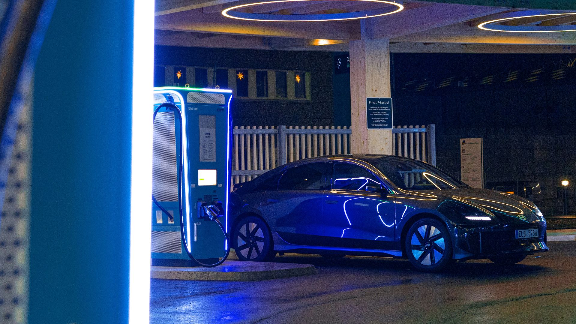 a blue car is parked at a gas station