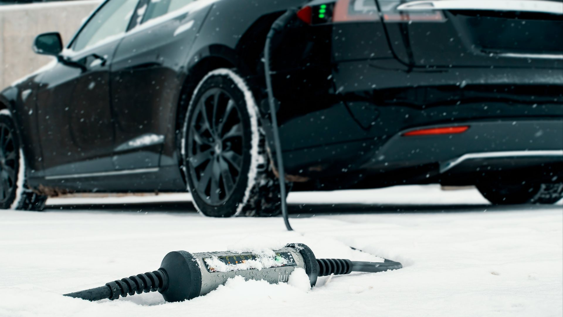 a car is parked in the snow next to a screwdriver