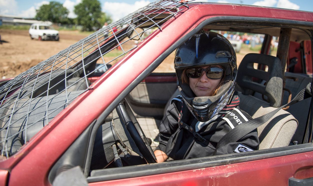 A woman driver in the car during Italian Demolition Derby. The Demolition Derby was born around the 60s in America, is a car rally where the aim is to destroy opponents through the ramming, is usually celebrated during village festivals or festivals.