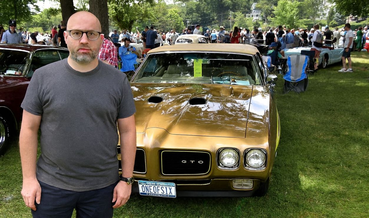 Man standing in front of Pontiac GTO Judge Ram Air IV