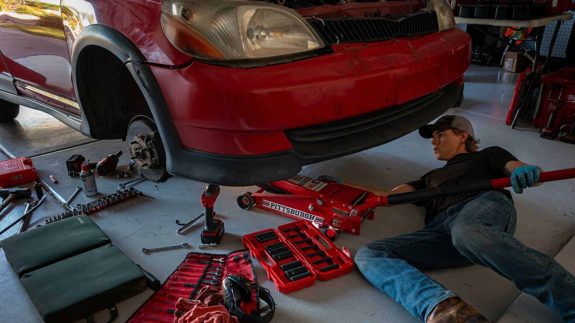 a man working on a car in a garage