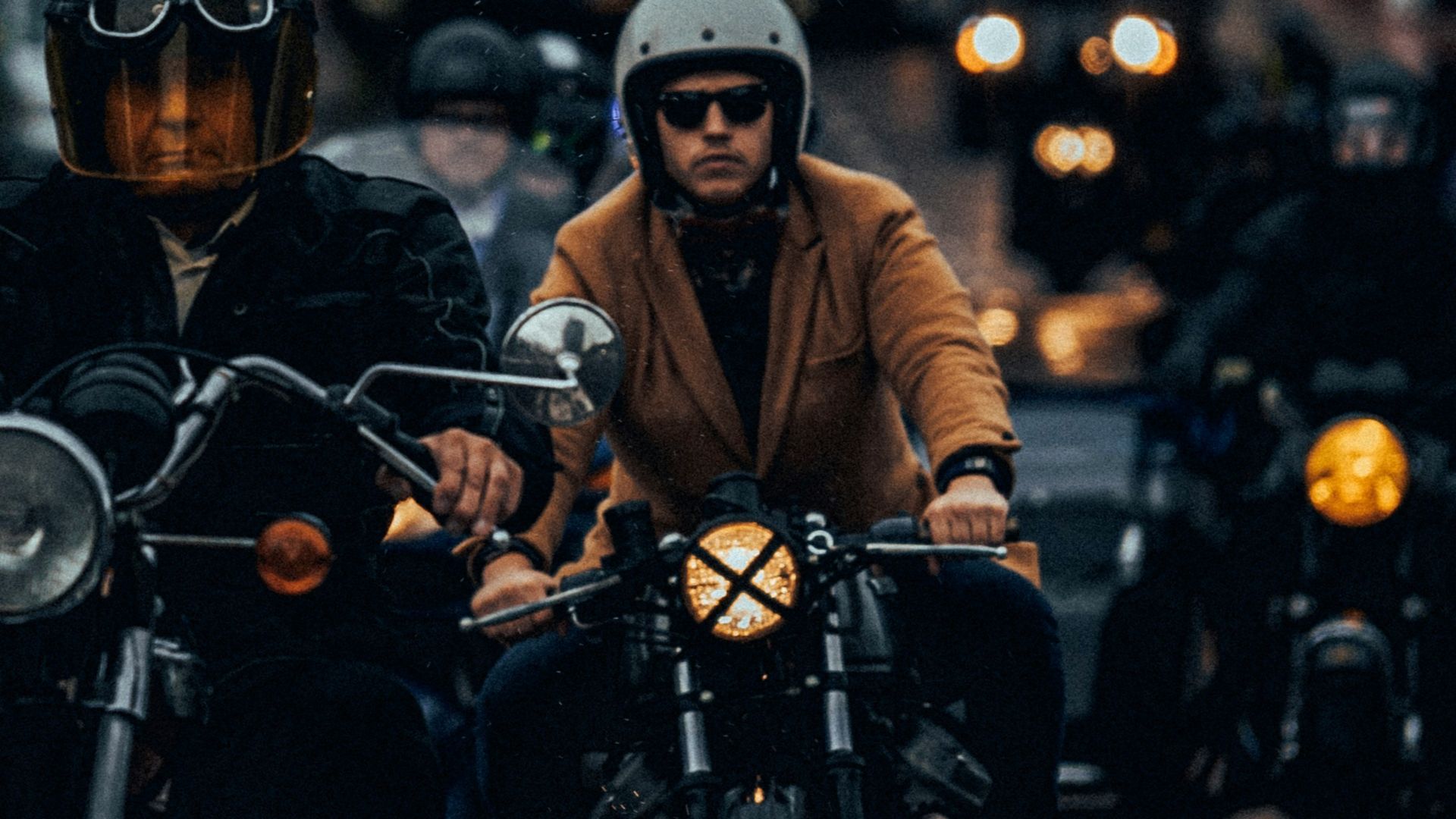 man riding on black motorcycle close-up photography