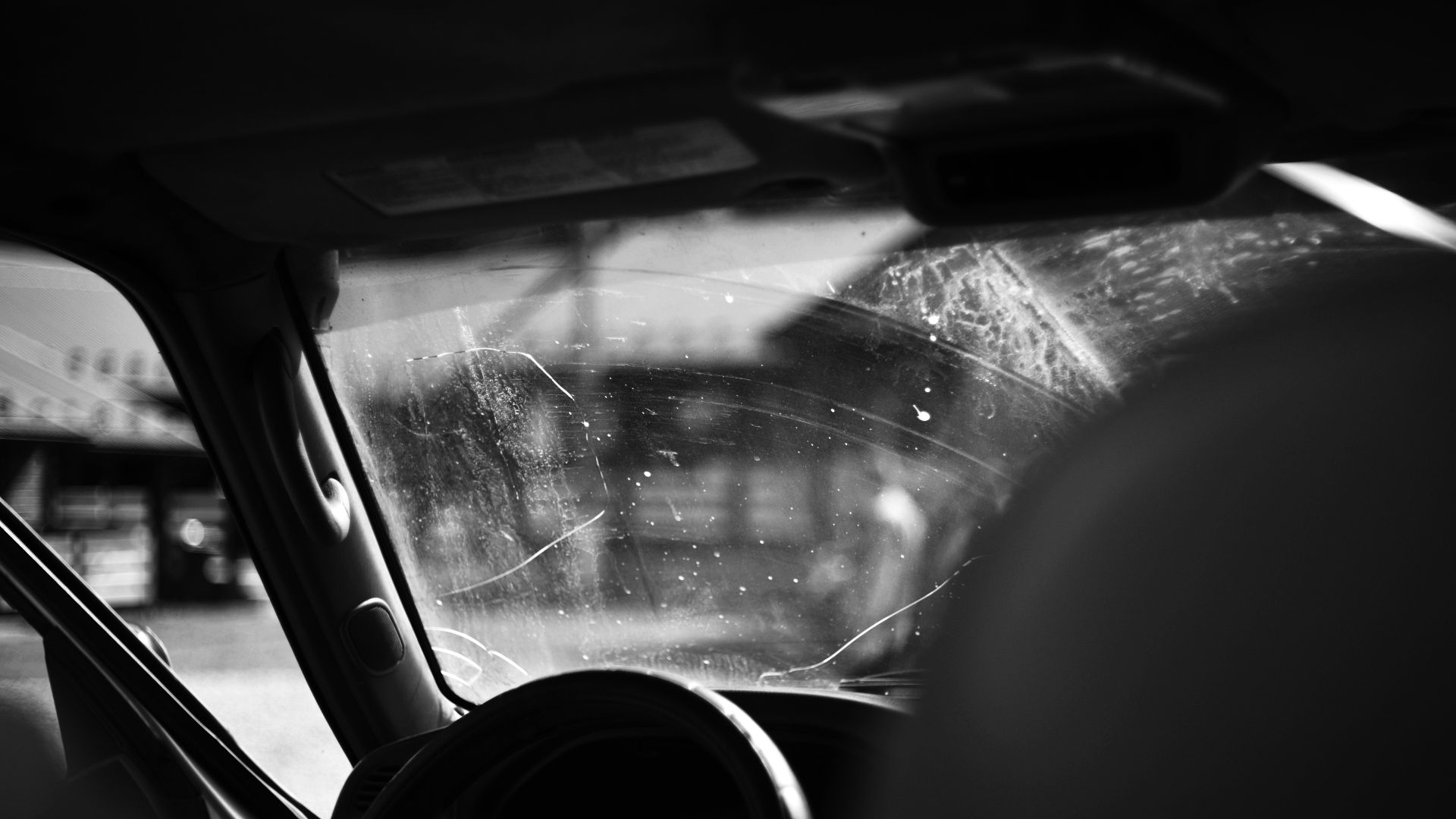 A black and white photo of the inside of a car