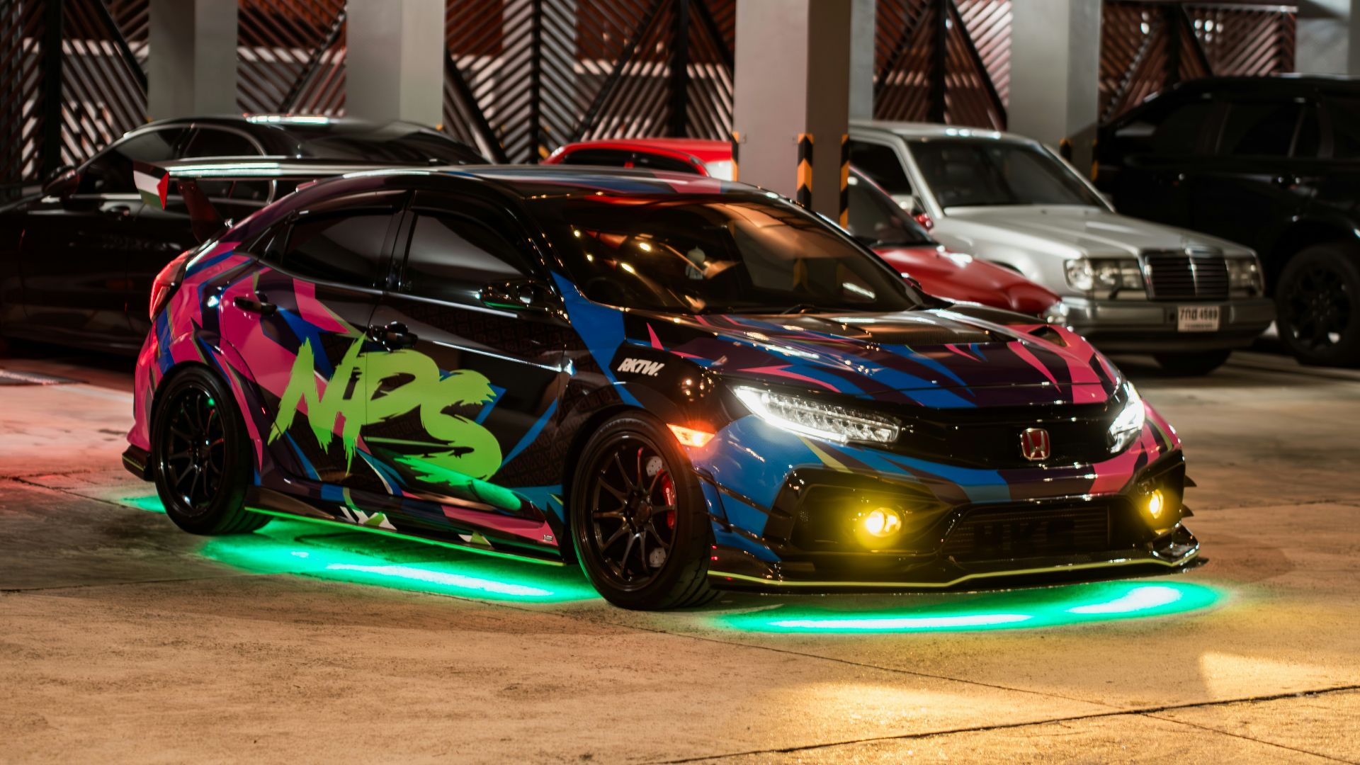 A car with neon lights parked in a parking lot