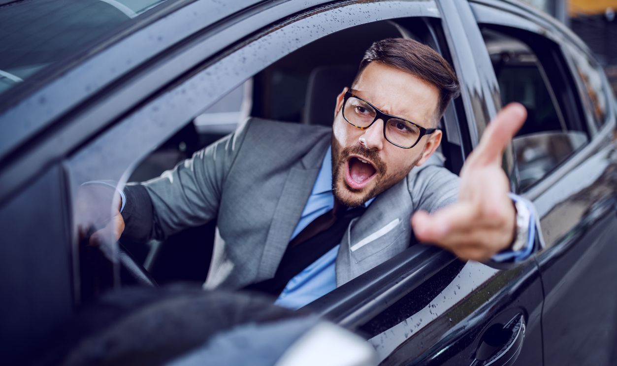 A sharp dressed man finding himself caught in a rush hour and slowly succumbing to road rage.