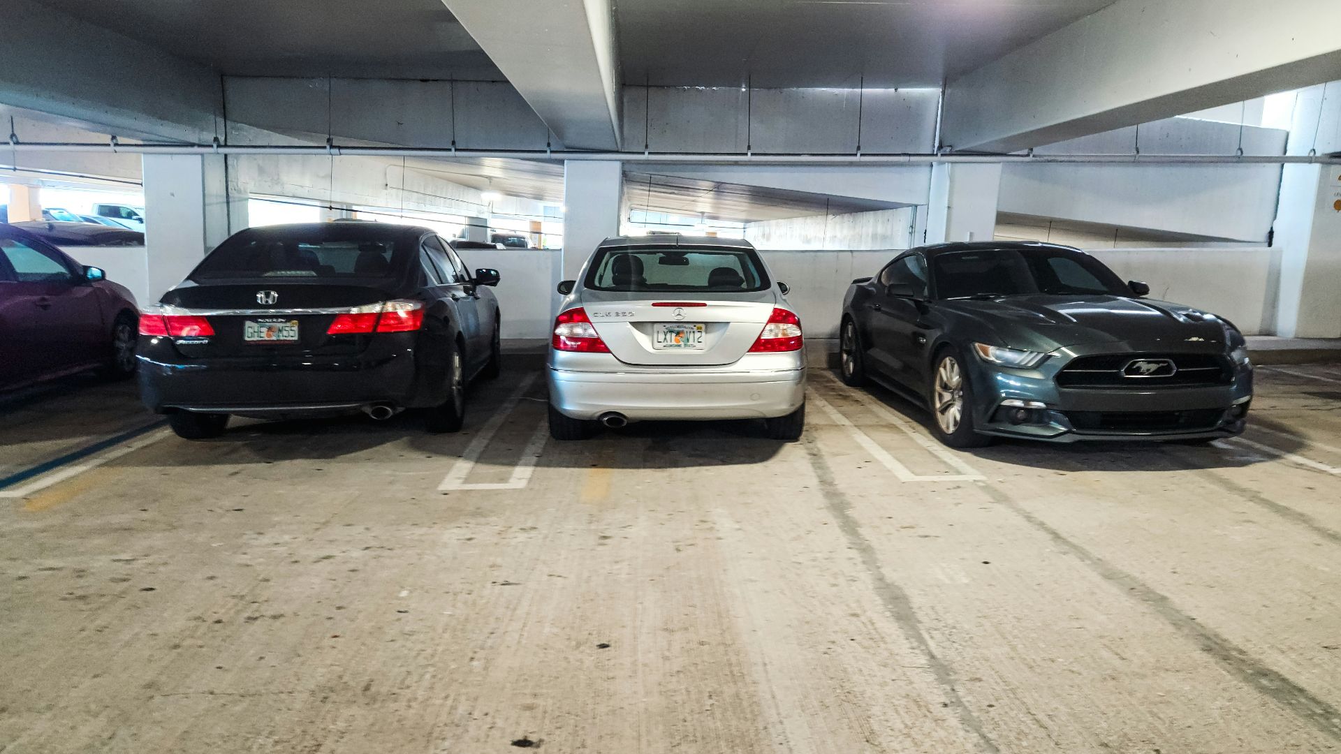 A group of cars parked in a parking garage