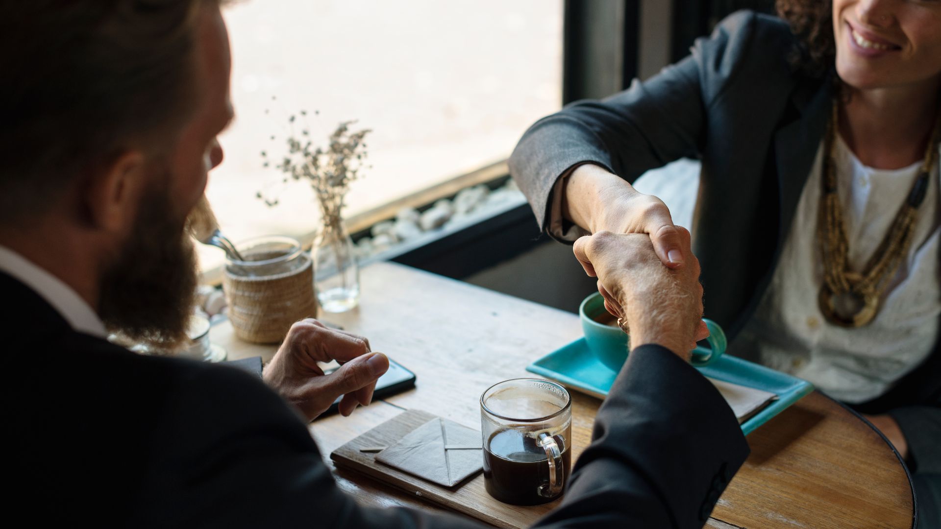 File:Business agreement handshake at coffee shop.jpg