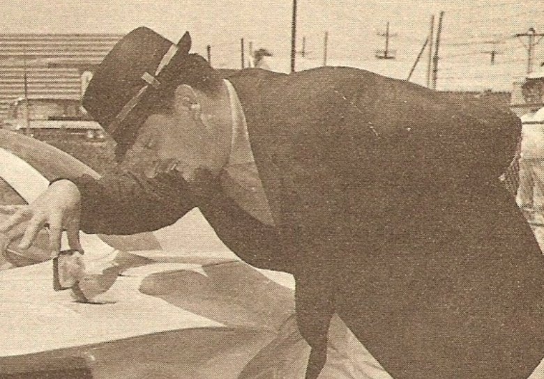 Ed Roth Leaning Over his Custom Car