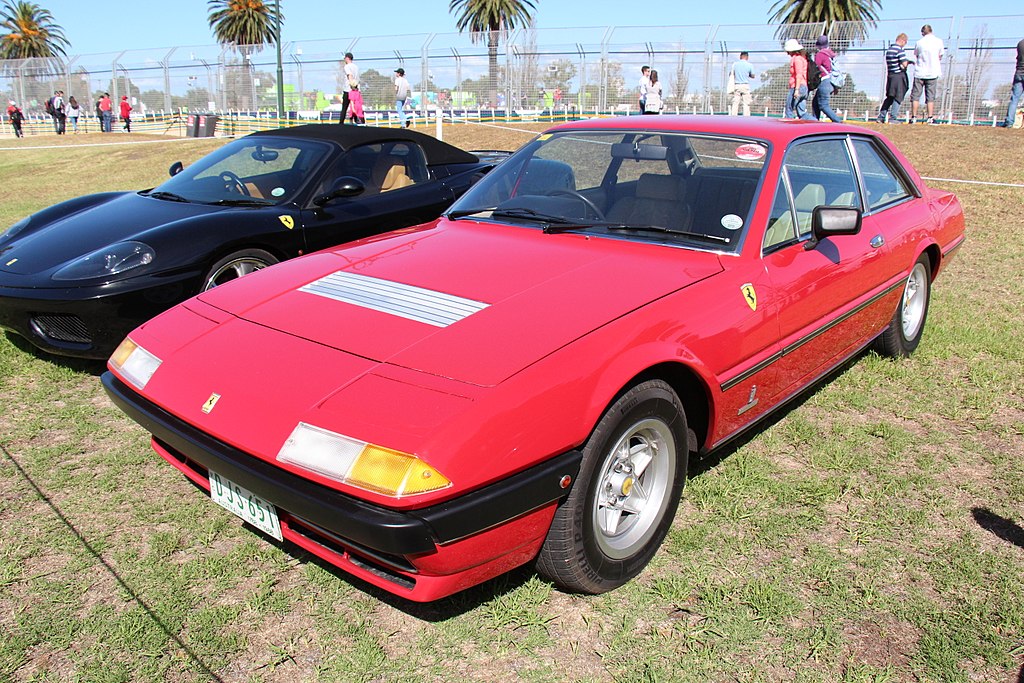 A close-up photo of a 1978 Ferrari 400 car on display at an exhibition