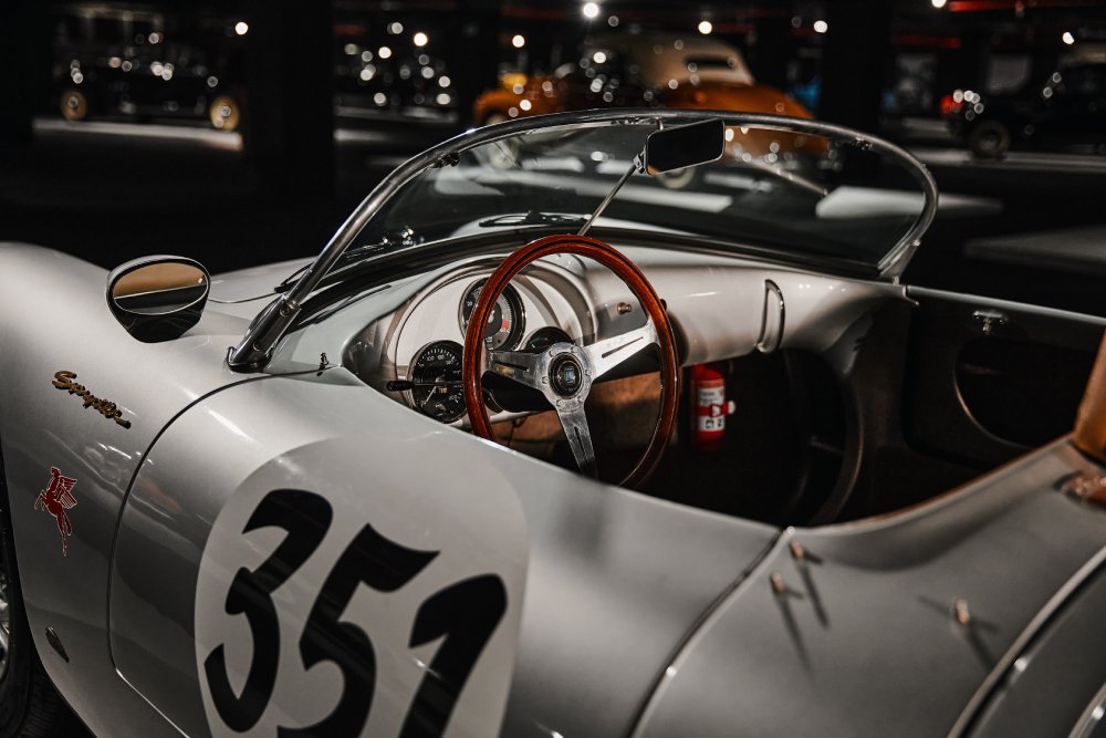 A close-up photo of a Porsche 550 Spyder car on display at an exhibition
