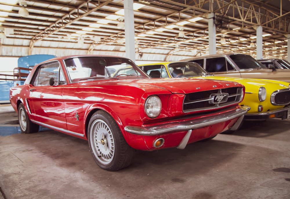 A close-up photo of a Vintage Ford Mustang car on display at an exhibition