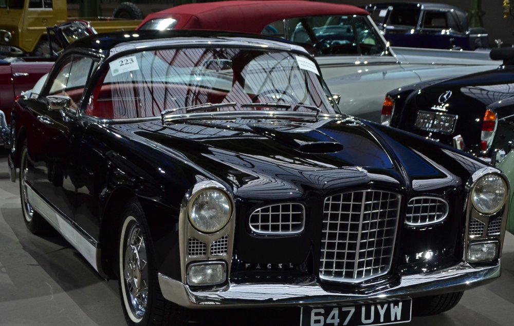 Row of vintage automobiles parked closely together