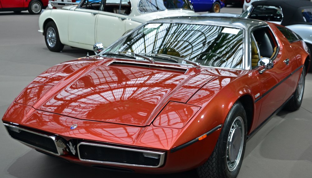 Row of vintage automobiles parked closely together