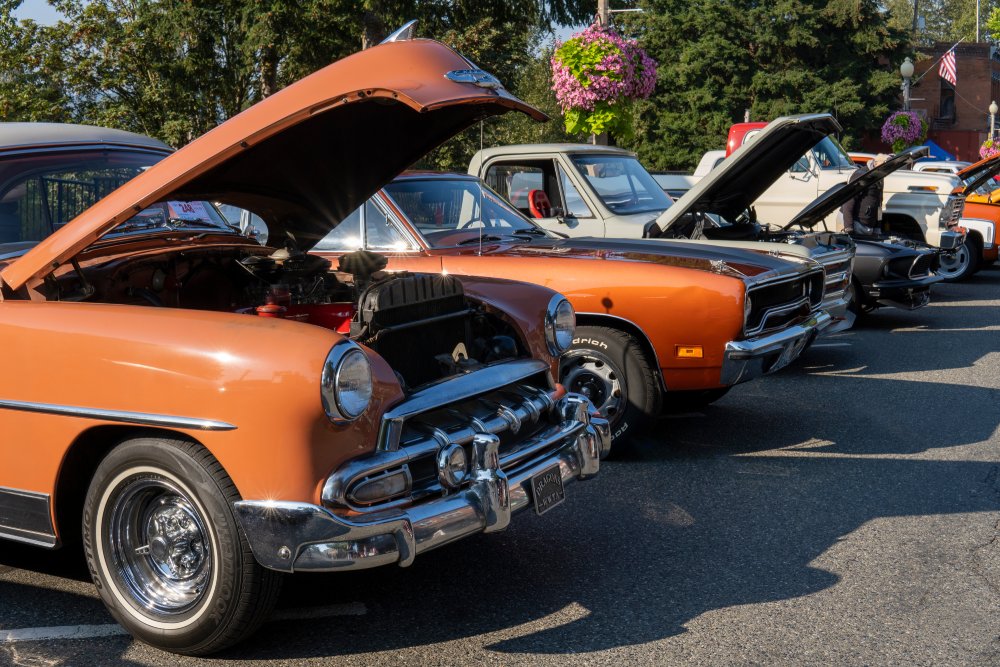 Side view of orange retro Chevrolet Bel Air with open car hood