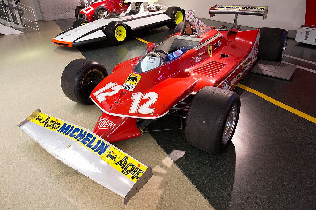 A close-up photo of a 1979 Ferrari 312 T4 car on display at an exhibition