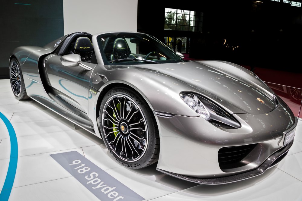 A close-up photo of a Porsche 918 Spyder car on display at an exhibition