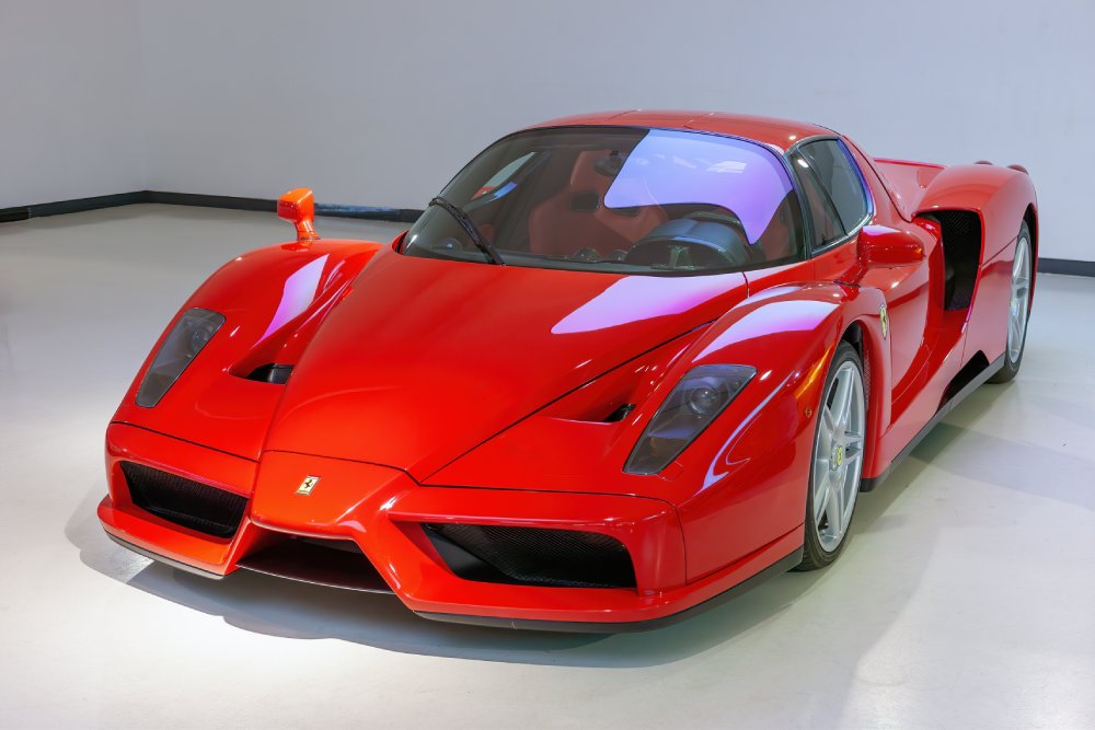 A close-up photo of a Ferrari Enzo car on display at an exhibition