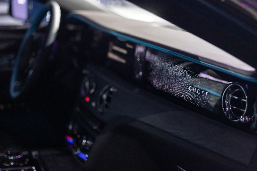 Luxury Rolls-Royce interior showcasing a sleek steering wheel and dashboard with high-end features and craftsmanship. Rolls-Royce Ghost model.