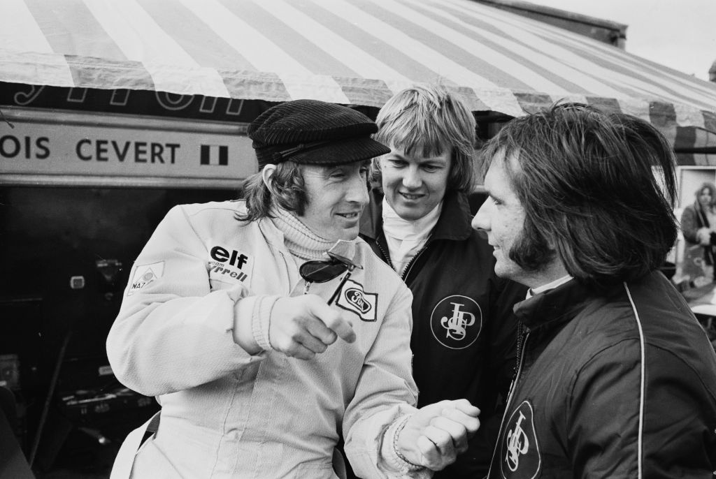 British racing driver Jackie Stewart in conversation with Swedish racing driver Ronnie Peterson
