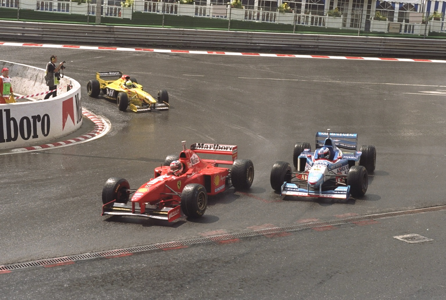 1997: Michael Schumacher of Germany driving his Ferrari (left) overtakes the Benneton-Renault of Jean Alesi