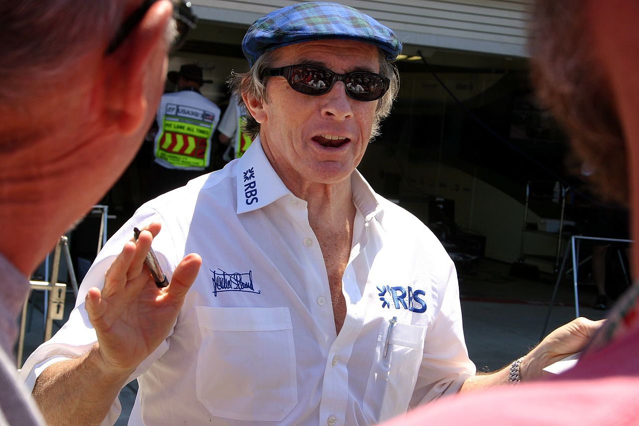 Jackie Stewart greets fans in the pit lane at the 2005 United States Grand Prix