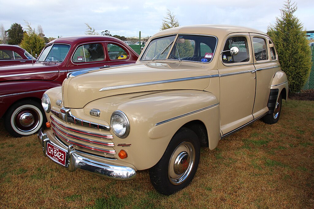 A close-up photo of a 1946 Ford Super Deluxe car on display at an exhibition