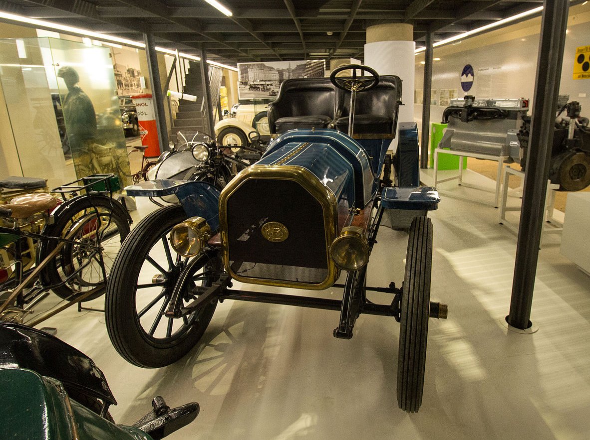 A close-up photo of a Baker Electric Runabout car on display at an exhibition
