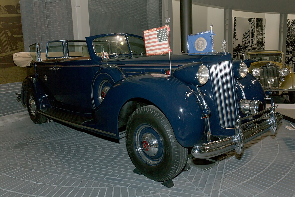A close-up photo of a Packard Twelve car on display at an exhibition