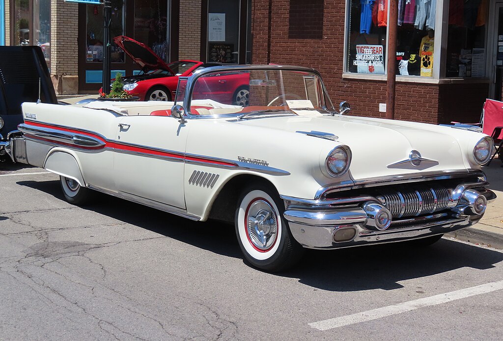 A close-up photo of a 1957 Pontiac Bonneville car on display at an exhibition