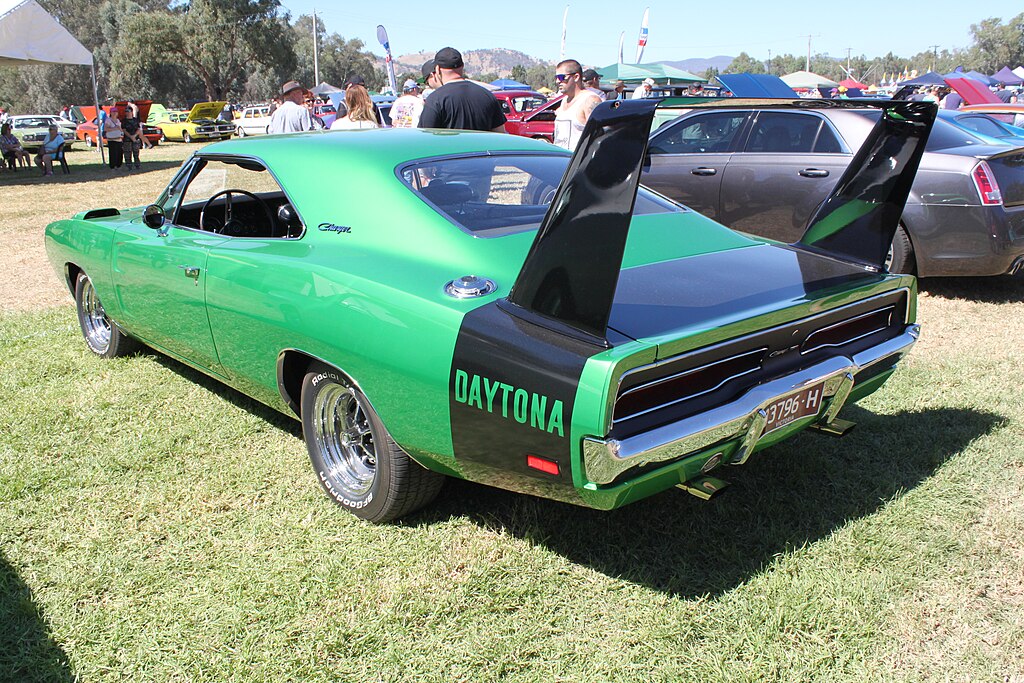 A close-up photo of a Dodge Charger Daytona 1969 car on display at an exhibition