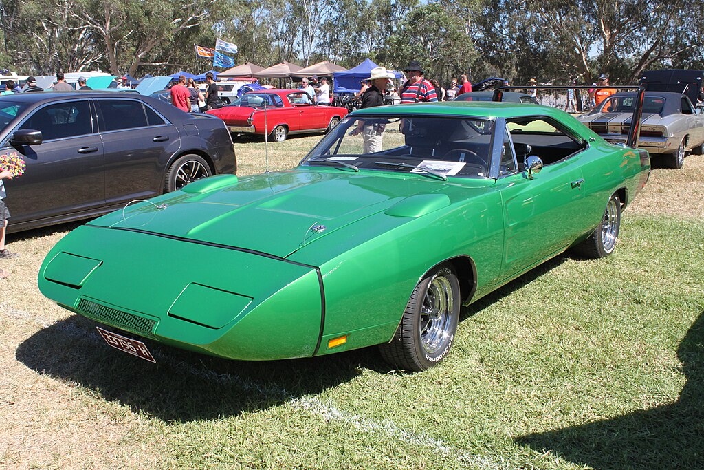 A close-up photo of a Dodge Charger Daytona 1969 car on display at an exhibition