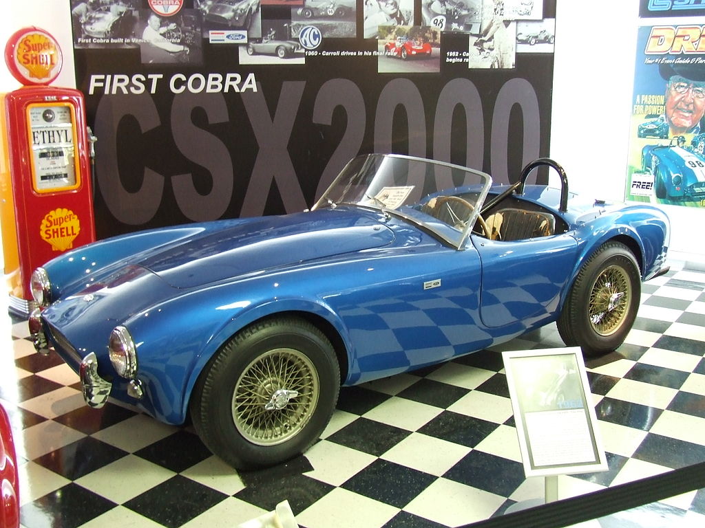 A close-up photo of a Shelby AC Cobra, CSX2000 car on display at an exhibition