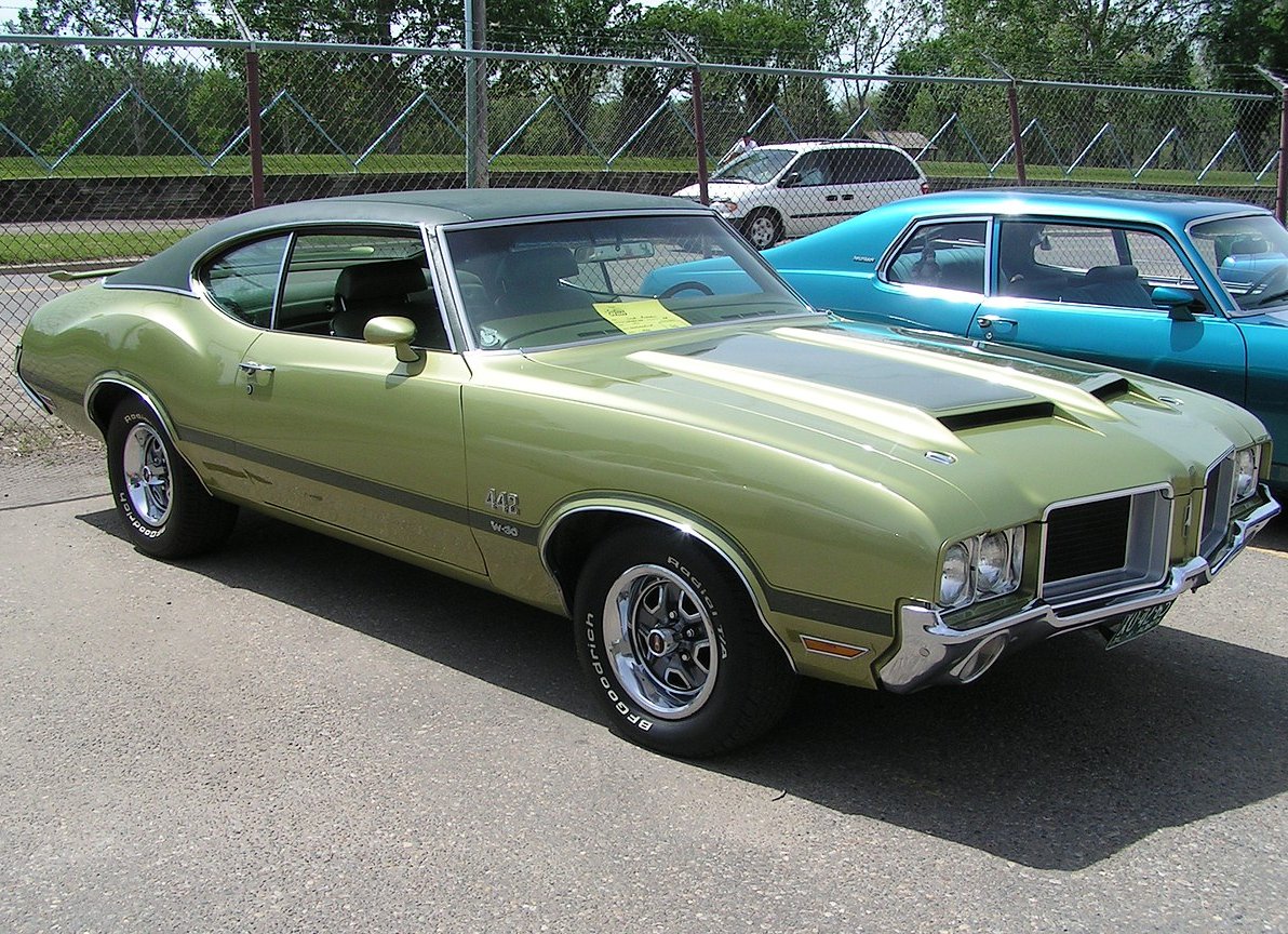 A close-up photo of a 1971 Oldsmobile 442 car parked in a parking lot