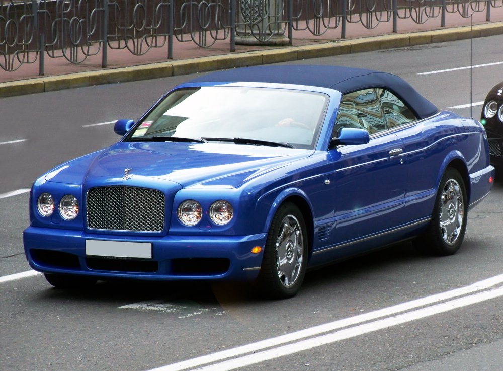 A close-up photo of a 1998 Bentley Azure car in motion
