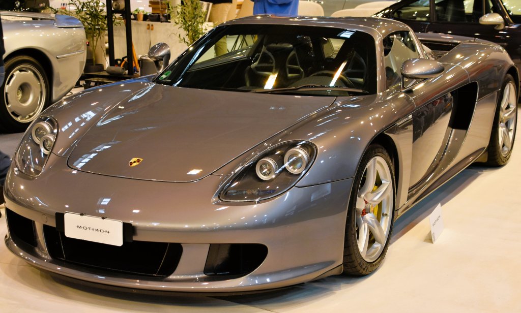 A close-up photo of a 2004 Porsche Carrera GT car on display at an exhibition