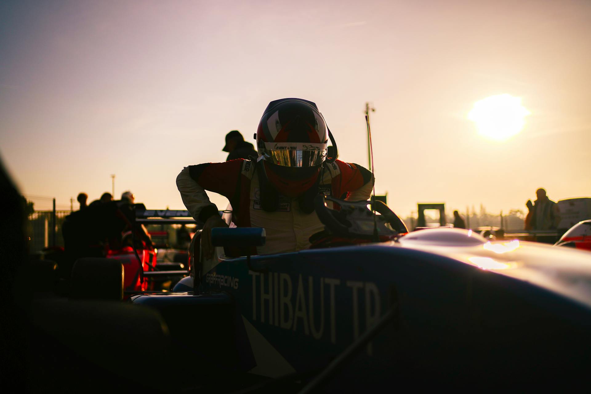 Driver with Helmet Entering Formula Car