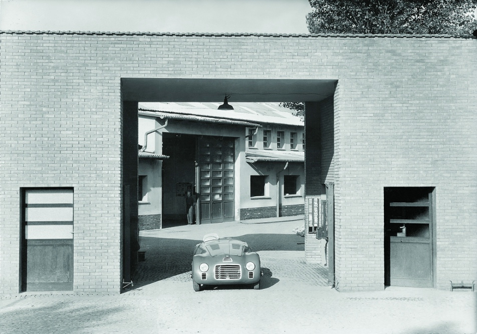 FIrst Ferrari, the 1947 125S s/n 01C at the factory gates in Maranello. It debuted 11 May 1947