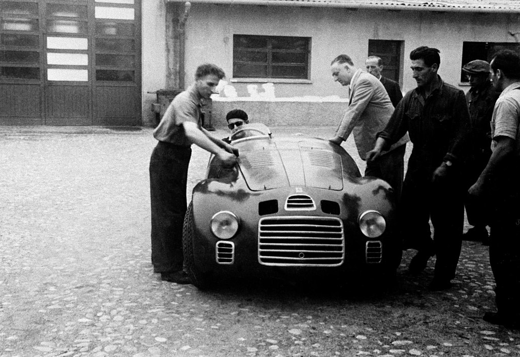 The 1947 Ferrari 125 S s/n 01C at the factory. Enzo Ferrari leaning on car.
