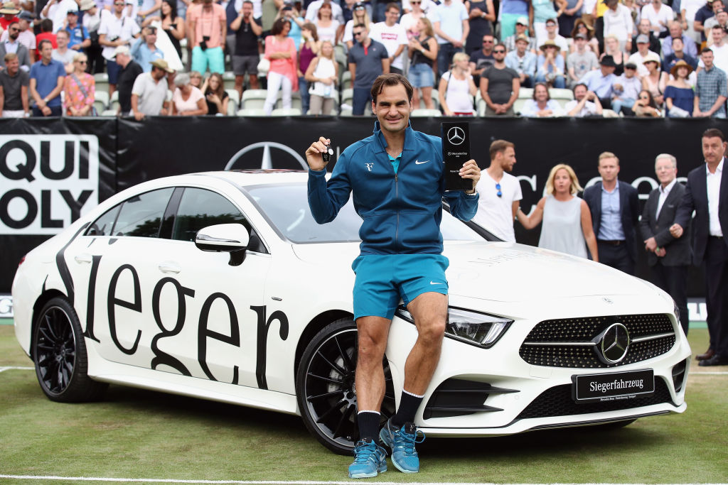 Roger Federer of Switzerland poses with his new Mercedes-Benz CLS 450 4MATIC Coupe