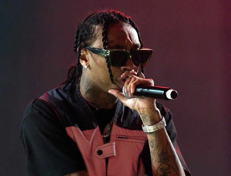 Tyga holding a microphone