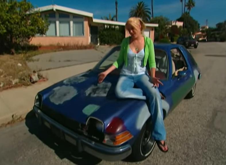 Girl sitting on an AMC pacer 