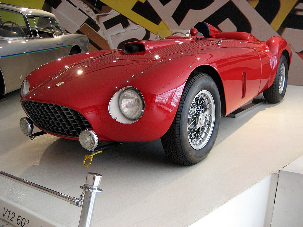 A close-up photo of a Ferrari 375 Plus Spider car on display at an exhibition