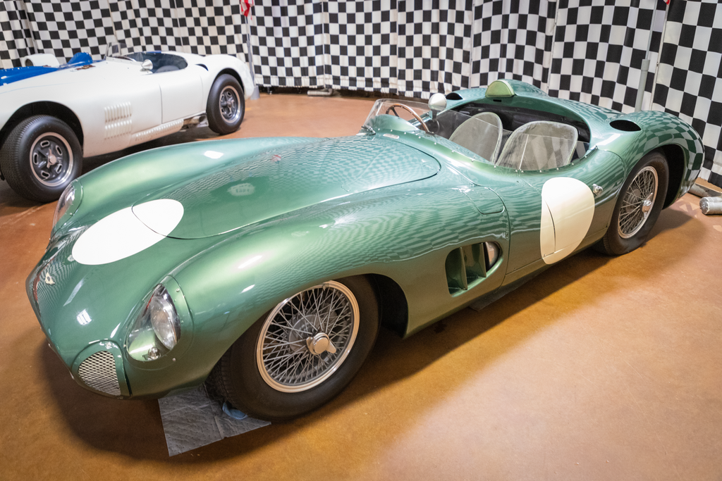 A close-up photo of a Aston Martin DBR1 car on display at an exhibition
