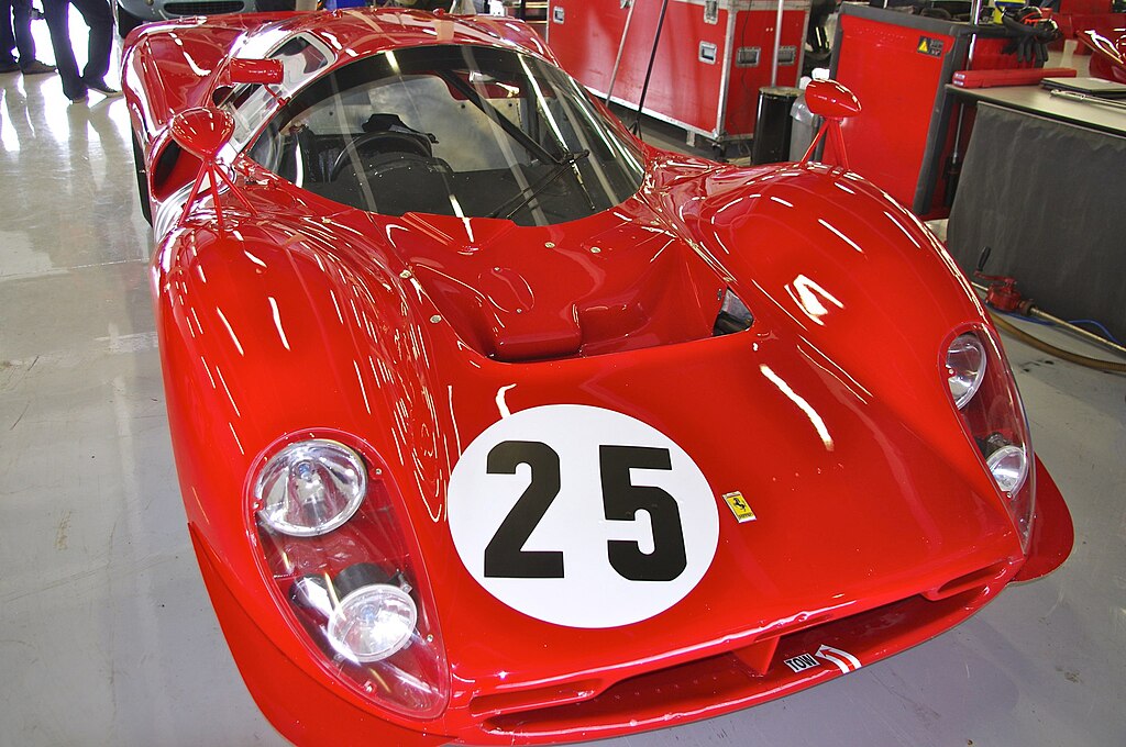 A close-up photo of a Ferrari 412P car on display at an exhibition